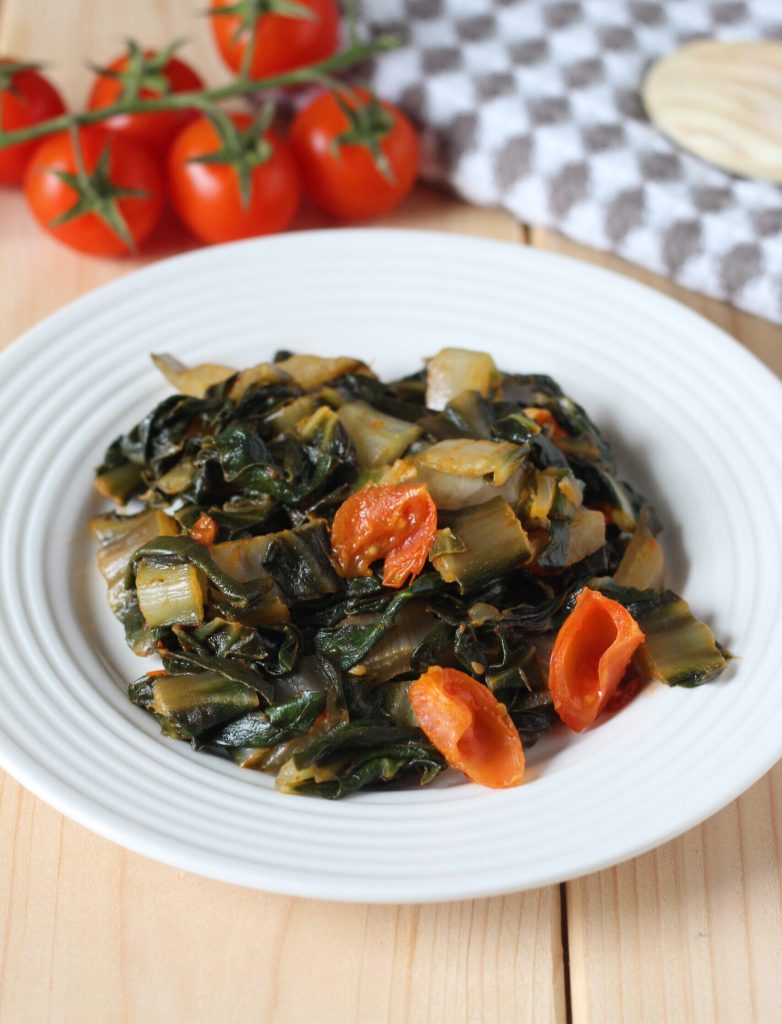 chard with cherry tomatoes in a pan