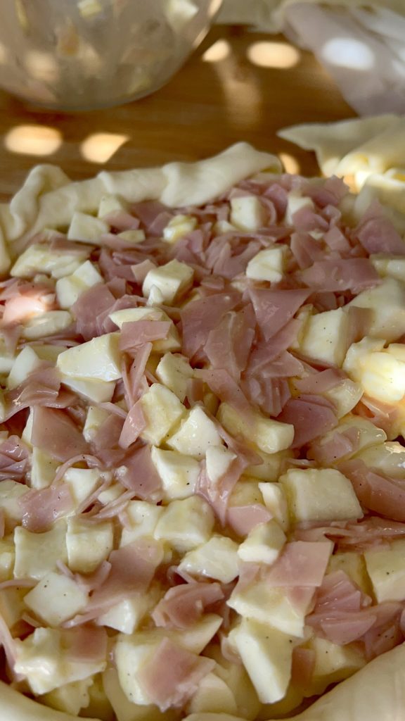 Filling spread over the puff pastry before sealing