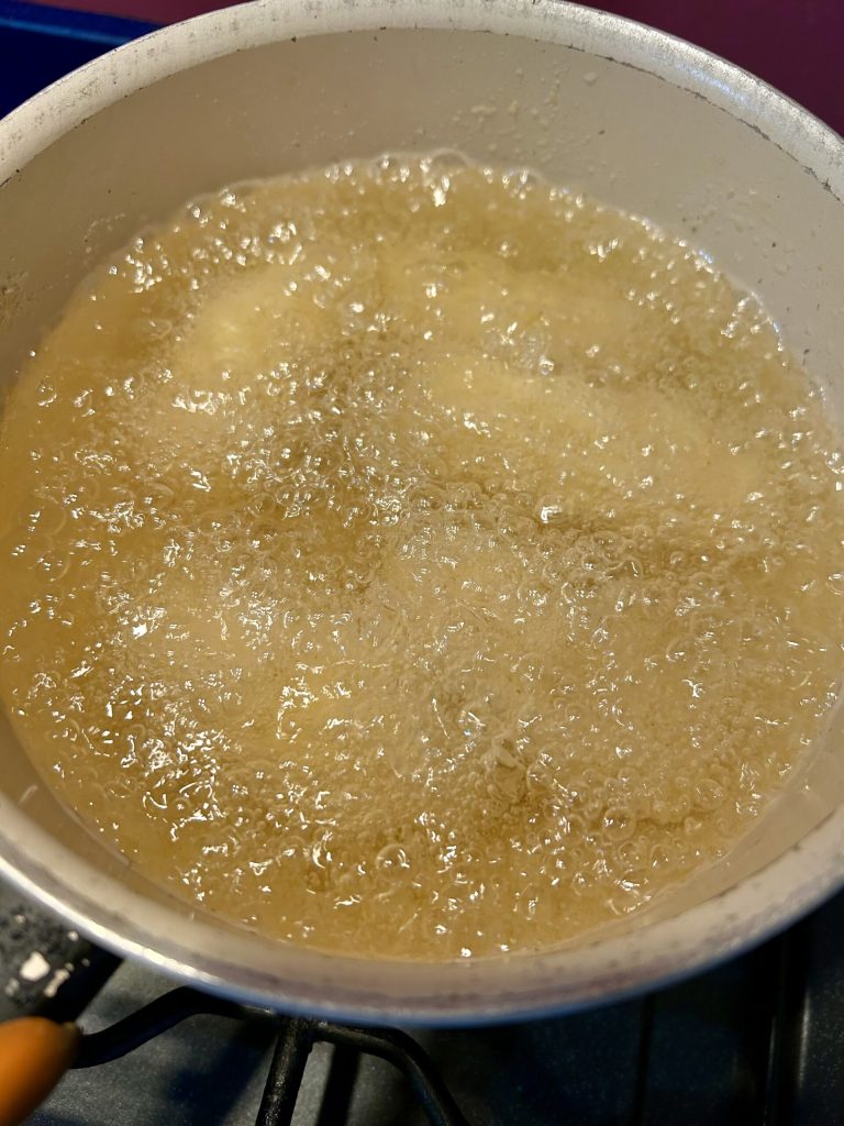potato croquettes frying in hot oil