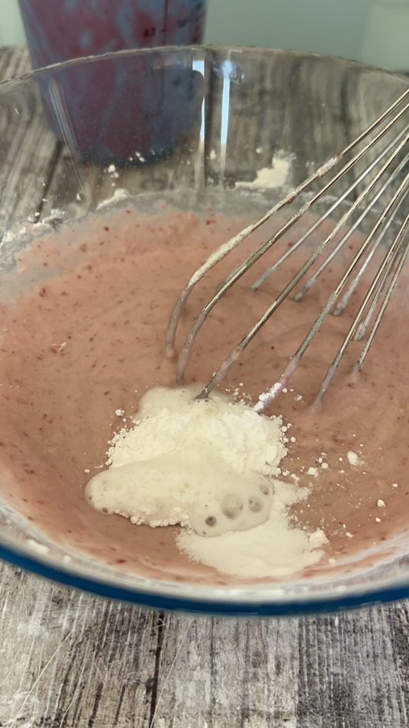 strawberry pancake batter with strawberry purée and flour in the bowl