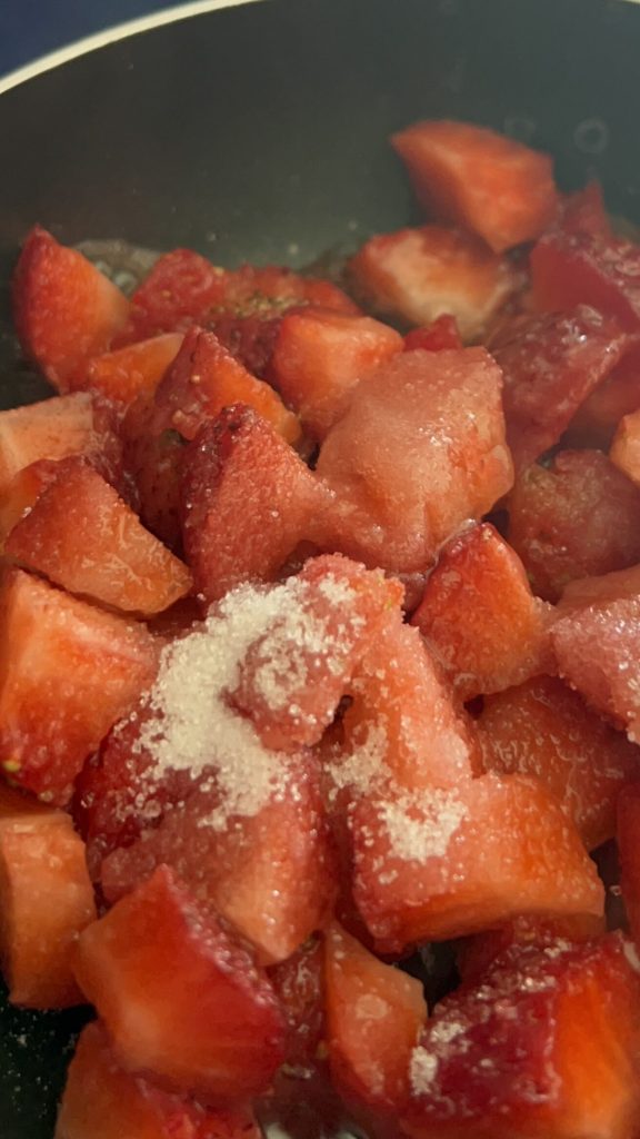 strawberries cut with sugar in a pan for pancake sauce