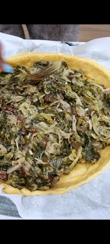 Distributing the escarole filling