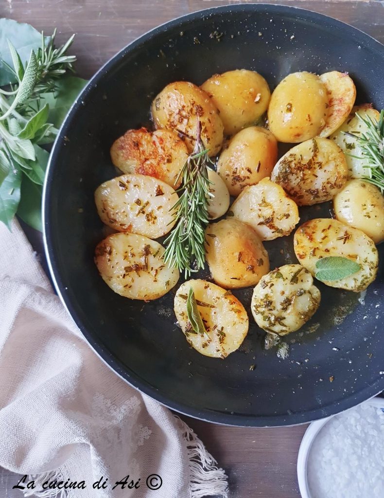 crispy new potatoes in a skillet with aromatic herbs