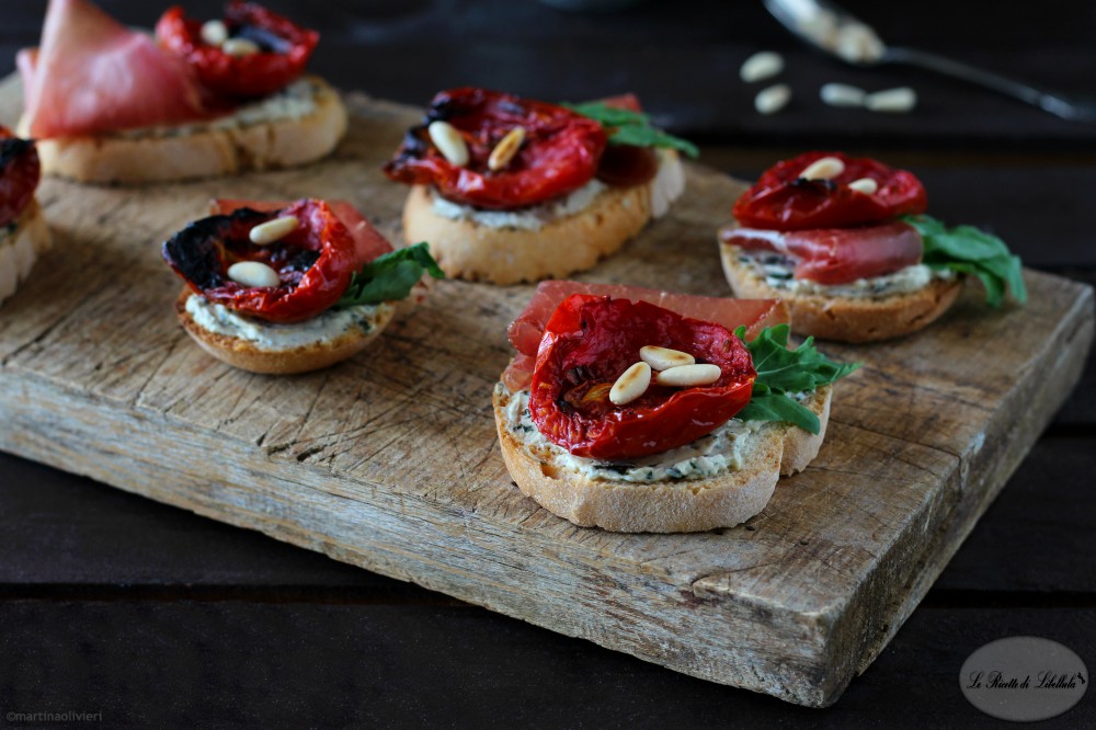 Crostini with bresaola, roasted tomatoes and cheese