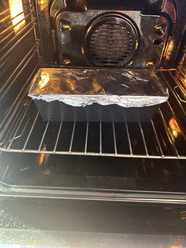 eggplant pasta in the mold covered with foil during oven baking