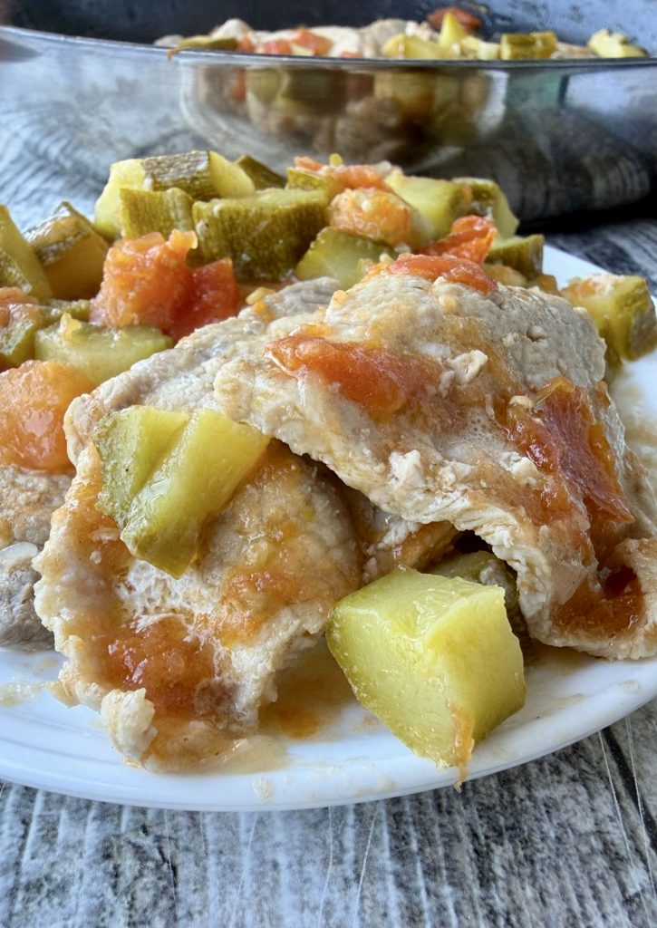 Soft and juicy pan-fried pork loin slices with zucchini and tomatoes