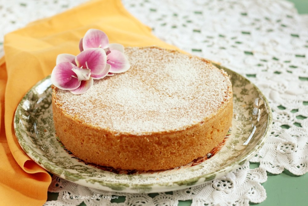 Paradise Cake made with only egg yolks dusted with plenty of powdered sugar on a serving plate.