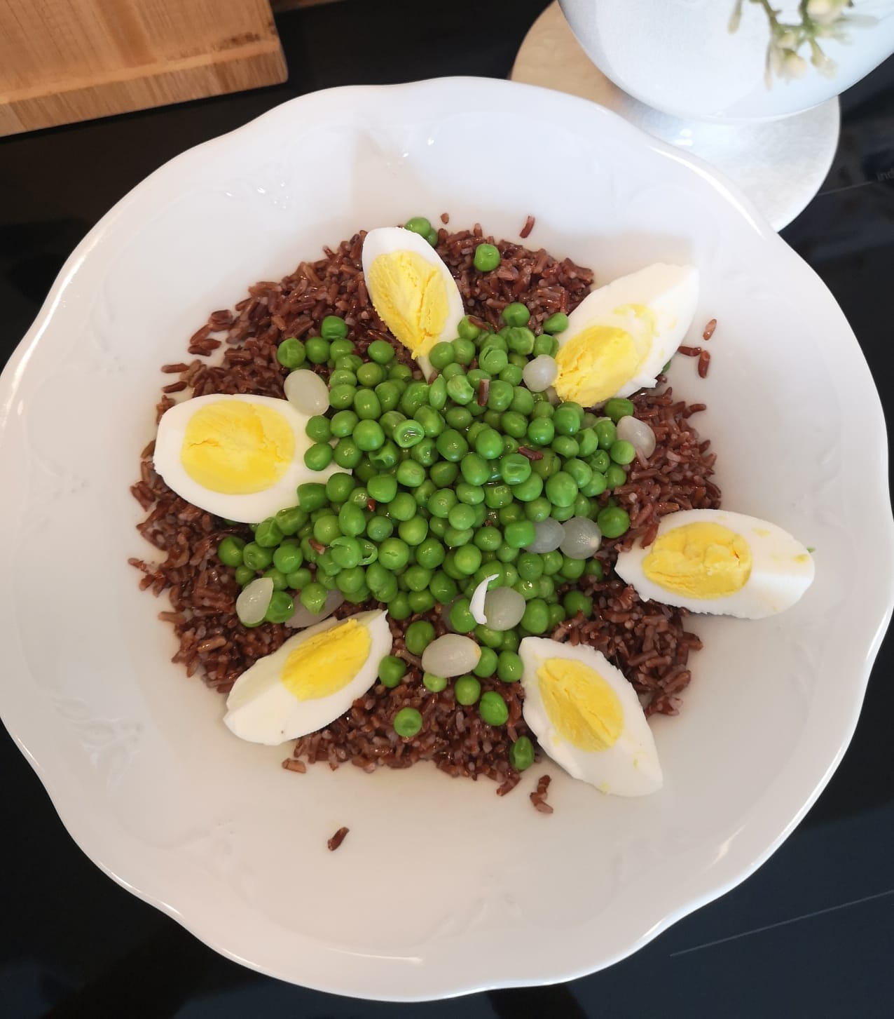 Red rice with peas, hard-boiled eggs and pickled pearl onions