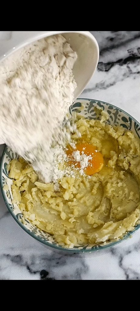 Wir fügen den Kartoffeln Ei und Mehl hinzu