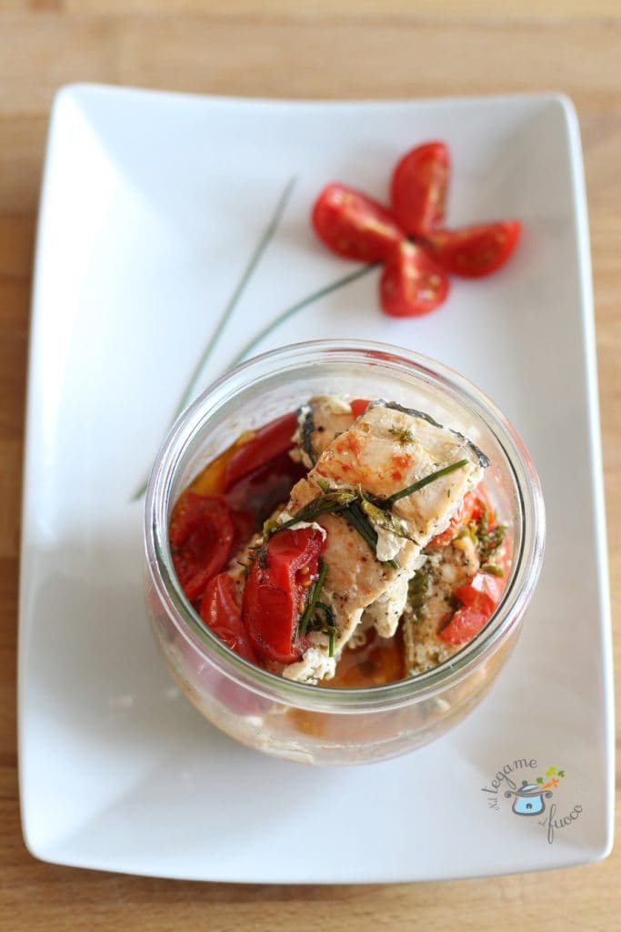 Lachsstücke mit Kirschtomaten und Kräutern im Einmachglas in der Mikrowelle mit der Technik der Vasocottura gekocht