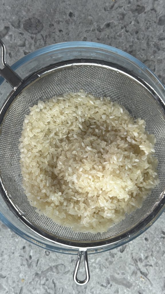 Reis im Sieb abtropfen lassen
