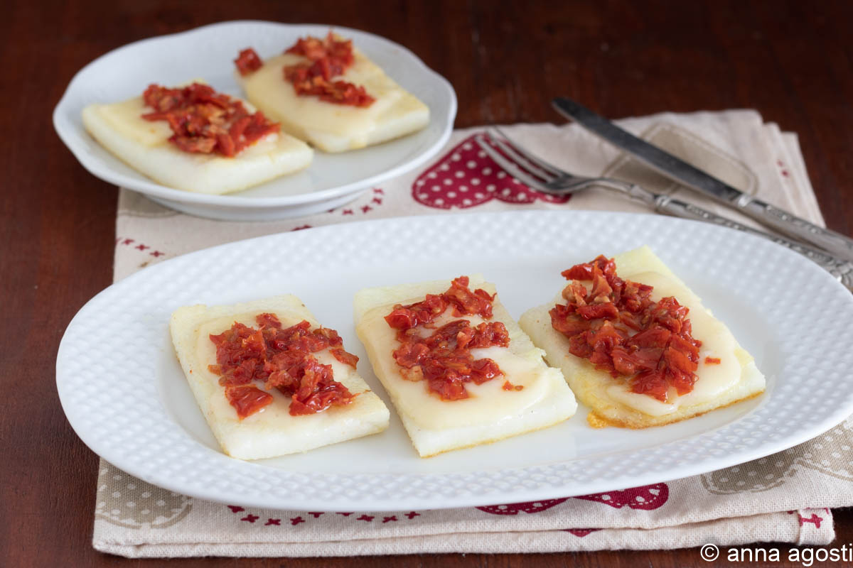 Crostini de polenta blanche avec fromage et tomates