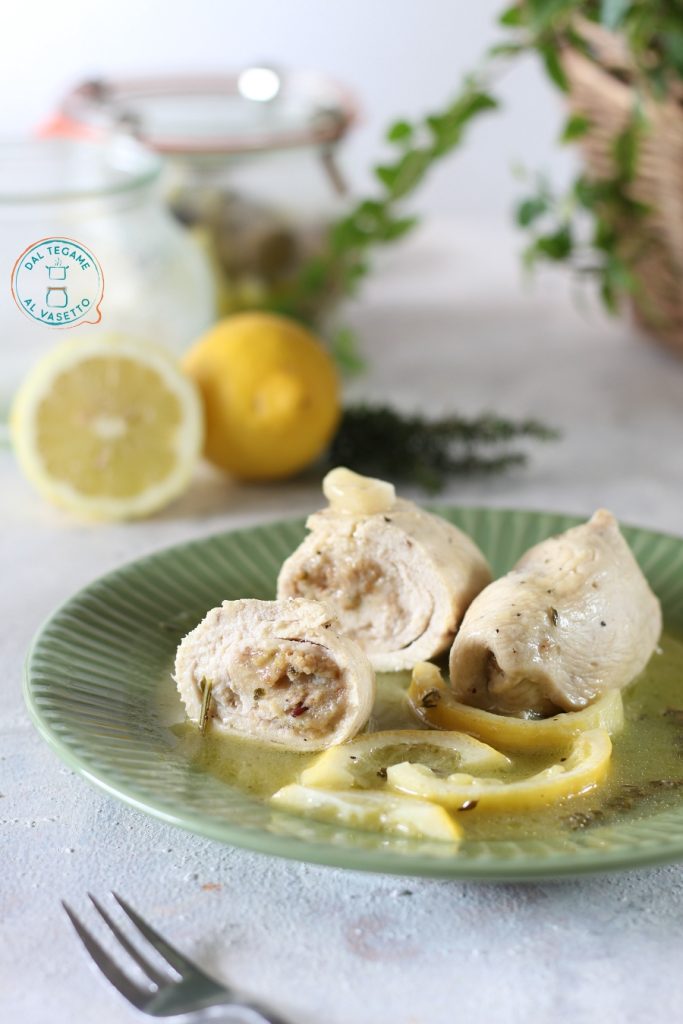 filetes de pechuga de pollo finos rellenos en forma de rollito con rodajas de limón y cocidos en tarro en el microondas