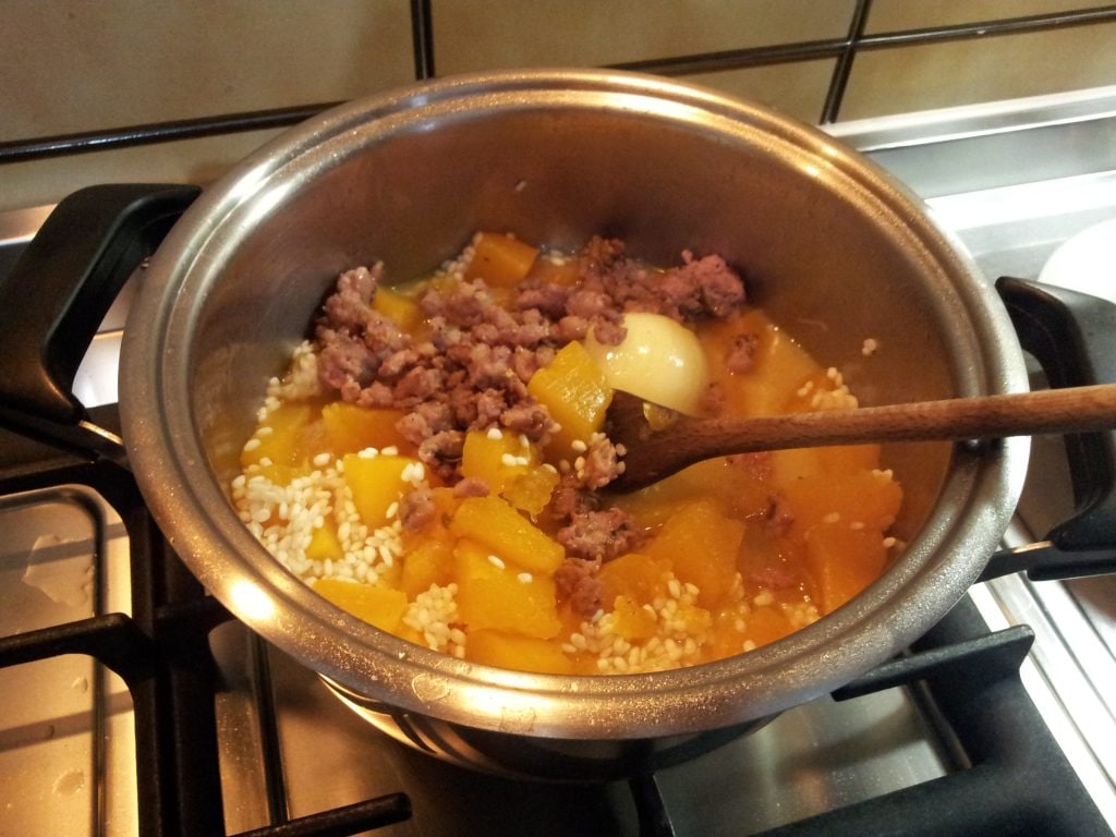 Risotto met pompoen en worst in bereiding