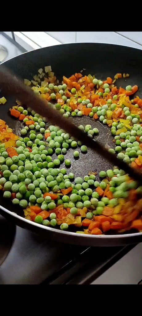Voeg curry, kurkuma en erwten toe