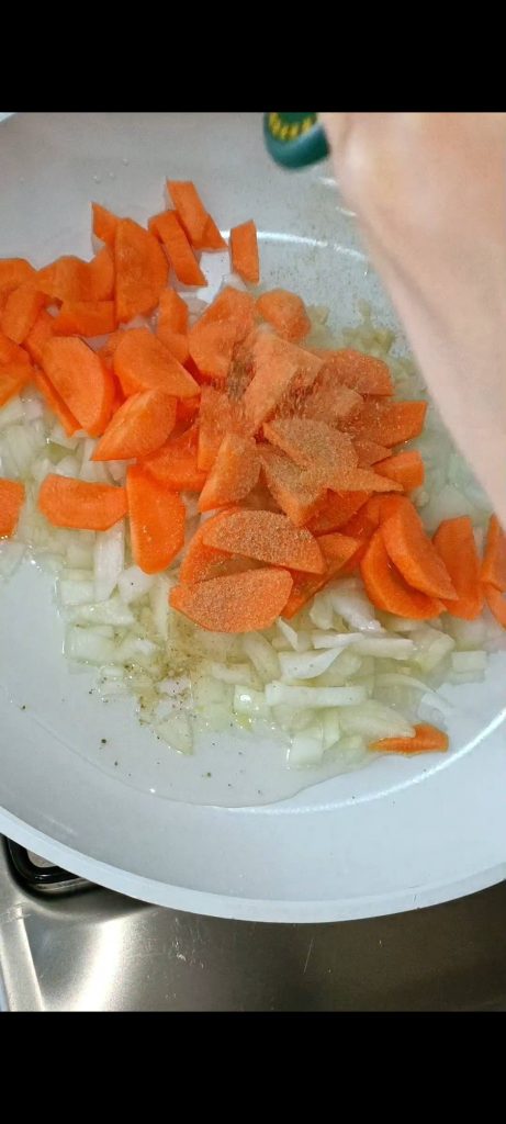Wortelen en ui in de pan