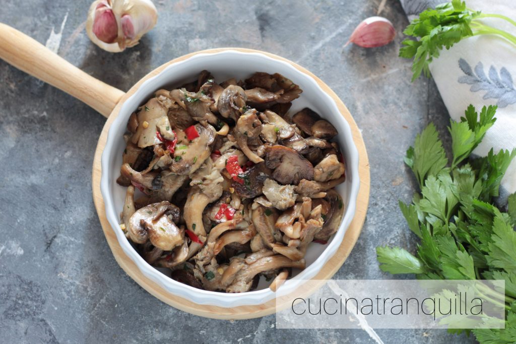 Gemengde paddenstoelen in de pan met knoflook en chilipeper