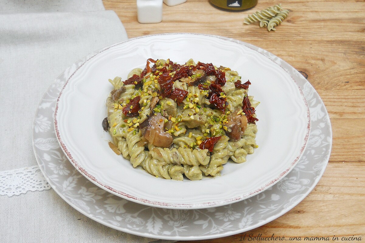 Fusilli met pistachepesto met eekhoorntjesbrood, stracciatella en zongedroogde tomaten