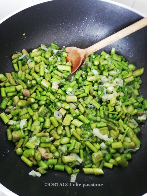 groene asperges in de pan met ui