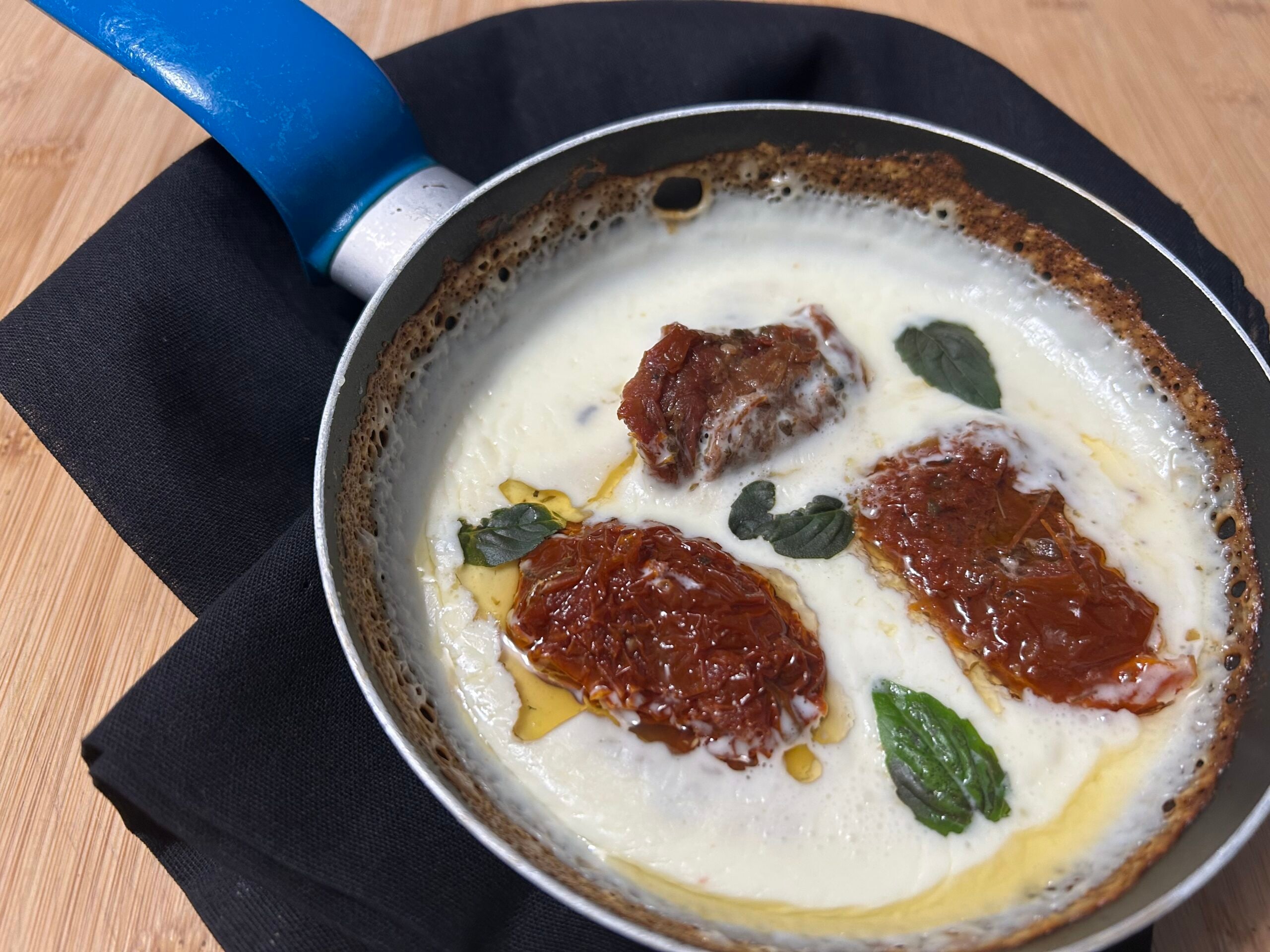 Gesmolten stracchino met gedroogde tomaten in olie