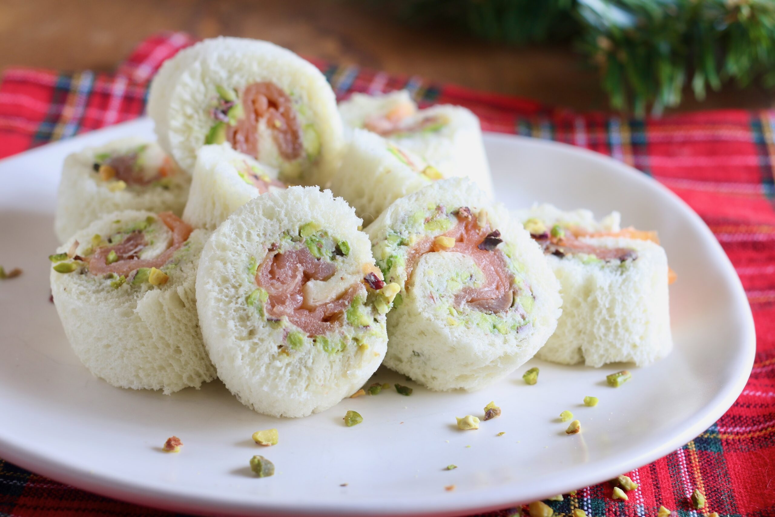 Rolletjes van witbrood met zalm, pistachenoten en smeerkaas